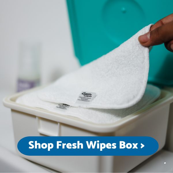 Picture of clean dry reusable wipes being placed into fresh wipes box